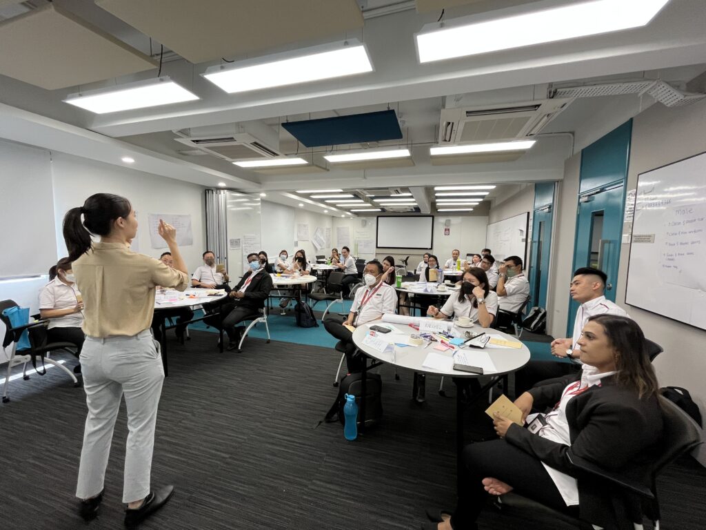 Yihua giving instructions to a group of attendees in training